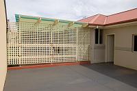  looking from the back lane to the patio & side door from the garage